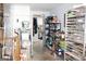 Room with commercial storage shelves and door leading to kitchen; cement flooring at 9342 Carillon Ct, Jonesboro, GA 30236