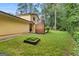 Back exterior view, showcases a patio and brick chimney at 423 Mephisto Cir, Lawrenceville, GA 30046