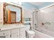 The bright bathroom has a tile shower/tub and mosaic-tiled mirror at 423 Mephisto Cir, Lawrenceville, GA 30046