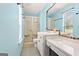 Bright bathroom with blue walls, walk-in shower, and vanity with countertop space at 423 Mephisto Cir, Lawrenceville, GA 30046