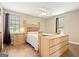 Comfortable bedroom features a ceiling fan, a large window, and light wood furniture at 423 Mephisto Cir, Lawrenceville, GA 30046