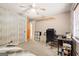 Bedroom features a desk, a single bed, and light-colored wood paneling at 423 Mephisto Cir, Lawrenceville, GA 30046