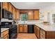 Well-lit kitchen featuring wooden cabinets, stainless steel appliances, and modern countertops at 423 Mephisto Cir, Lawrenceville, GA 30046