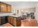 Bright kitchen features wood cabinets, granite countertops, and a view to the dining area at 423 Mephisto Cir, Lawrenceville, GA 30046