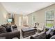 Cozy living room with plenty of natural light and comfortable sofas at 423 Mephisto Cir, Lawrenceville, GA 30046