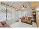 Relaxing sunroom offering cozy seating, soft natural light, and a ceiling fan for comfort at 423 Mephisto Cir, Lawrenceville, GA 30046