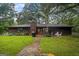 Charming home with a lush backyard, patio area, and well-manicured lawn, perfect for outdoor entertaining and relaxation at 69 Trace Ct, Stockbridge, GA 30281