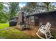 Inviting backyard patio with outdoor seating, a grill, and a well-maintained lawn, perfect for outdoor relaxation and gatherings at 69 Trace Ct, Stockbridge, GA 30281