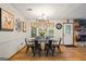 Cozy dining room with stone fireplace, wood floors, and natural light at 69 Trace Ct, Stockbridge, GA 30281