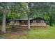 Charming single-story home with stone accents and a welcoming front porch, nestled among mature trees in a quiet setting at 69 Trace Ct, Stockbridge, GA 30281
