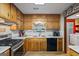 Traditional kitchen featuring wood cabinetry, stainless steel appliances, and bright countertops at 69 Trace Ct, Stockbridge, GA 30281