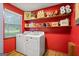 Functional laundry room equipped with a washer, dryer, storage shelves, and a bright, clean atmosphere for easy chores at 69 Trace Ct, Stockbridge, GA 30281