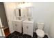 Bright bathroom featuring double sink vanity, black and white tile floor, and modern lighting at 155 Glenwood Ln, Fayetteville, GA 30215