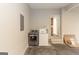 A spacious laundry room with modern washer and dryer setup and steps leading to an interior door at 155 Glenwood Ln, Fayetteville, GA 30215