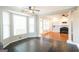 Open-concept living and dining area boasts fireplace, built-in shelving, and beautiful hardwood floors at 155 Glenwood Ln, Fayetteville, GA 30215