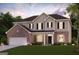Charming two-story home featuring a brick and siding exterior, well-manicured lawn, and a two-car garage at 817 Dobby Way # 96, Mcdonough, GA 30252