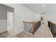 Upstairs hallway with carpet floors, neutral paint, and doors leading to additional rooms at 817 Dobby Way # 96, Mcdonough, GA 30252