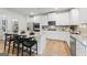 Modern kitchen with white cabinets, stainless appliances, island and wooden floor at 817 Dobby Way # 96, Mcdonough, GA 30252