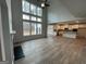 Spacious living room with soaring ceilings, large windows, and an open floor plan with hardwood style flooring at 817 Dobby Way # 96, Mcdonough, GA 30252