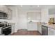 Well-equipped kitchen boasts granite countertops, stainless steel appliances, and sleek gray cabinetry at 5449 Baybrook Cir, South Fulton, GA 30349