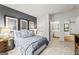 Modern bedroom featuring a neutral color palette, decorative wall, and ensuite bathroom at 821 Dobby Way # 97, Mcdonough, GA 30252