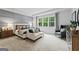 Serene main bedroom with large windows, a cozy sitting area, and stylish décor at 821 Dobby Way # 97, Mcdonough, GA 30252