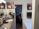 Compact bathroom with granite countertop, a decorative mirror and fixtures, and an open doorway to bedroom at 521 Deadwood Trl, Locust Grove, GA 30248
