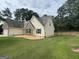 Well maintained home with a large, green lawn and a small rock garden area with small bordering lights at 521 Deadwood Trl, Locust Grove, GA 30248