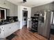 Well-organized kitchen features stainless steel appliances, gray cabinets, and a view into the laundry room at 521 Deadwood Trl, Locust Grove, GA 30248
