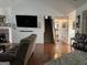 Inviting living room featuring hardwood floors, a cozy fireplace, and a staircase leading to the upper level at 521 Deadwood Trl, Locust Grove, GA 30248