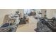 Spacious living room with carpeted floors, a floral sofa, and workout equipment at 115 Glen Echo Dr, Covington, GA 30016