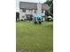 Spacious backyard with manicured lawn featuring a patio, perfect for outdoor living and entertaining at 12402 Muir Field Ct, Fayetteville, GA 30215