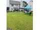 Large backyard with a well-manicured lawn and multiple seating areas, ideal for relaxation and gatherings at 12402 Muir Field Ct, Fayetteville, GA 30215