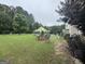 Expansive backyard featuring a lush lawn and multiple seating areas, perfect for outdoor entertaining at 12402 Muir Field Ct, Fayetteville, GA 30215