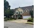 Charming two-story home with a brick facade and attached two-car garage at 12402 Muir Field Ct, Fayetteville, GA 30215