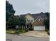 Charming two-story home with a brick facade and attached two-car garage at 12402 Muir Field Ct, Fayetteville, GA 30215