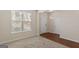Bright living room showcasing large windows and neutral carpeting at 11755 Lovejoy Crossing Blvd, Hampton, GA 30228