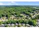Aerial view of a neighborhood with mature trees, well-maintained homes and winding roads at 1504 Oglethorpe Dr, Suwanee, GA 30024