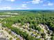 Scenic aerial view of a suburban neighborhood surrounded by trees, with a commercial area visible at 1504 Oglethorpe Dr, Suwanee, GA 30024