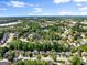 High aerial shot displays a neighborhood, showcasing homes amongst mature trees, and roadways at 1504 Oglethorpe Dr, Suwanee, GA 30024
