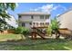 A two-story home features a multilevel wooden deck in a fenced backyard at 1504 Oglethorpe Dr, Suwanee, GA 30024