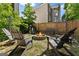 A stone fire pit creates a cozy outdoor space in the fenced backyard at 1504 Oglethorpe Dr, Suwanee, GA 30024