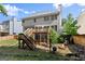 Backyard features a multilevel wooden deck with a fire pit area and privacy fence at 1504 Oglethorpe Dr, Suwanee, GA 30024