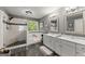 Bright bathroom with dual sinks, a soaking tub, and a separate glass enclosed shower at 1504 Oglethorpe Dr, Suwanee, GA 30024