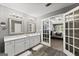 Bright primary bathroom with dual sinks and a doorway that leads into the primary bedroom at 1504 Oglethorpe Dr, Suwanee, GA 30024
