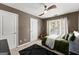 Comfortable bedroom with neutral carpet, a ceiling fan, and natural light at 1504 Oglethorpe Dr, Suwanee, GA 30024