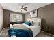 Comfortable bedroom with a ceiling fan, a window and a plush-looking bed at 1504 Oglethorpe Dr, Suwanee, GA 30024