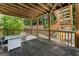 A covered deck features natural wood elements and leads down to the backyard at 1504 Oglethorpe Dr, Suwanee, GA 30024