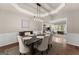 Elegant dining room featuring modern lighting and stylish décor, perfect for entertaining at 1504 Oglethorpe Dr, Suwanee, GA 30024
