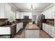 Bright kitchen with white cabinets, stainless appliances, island, and tile backsplash at 1504 Oglethorpe Dr, Suwanee, GA 30024